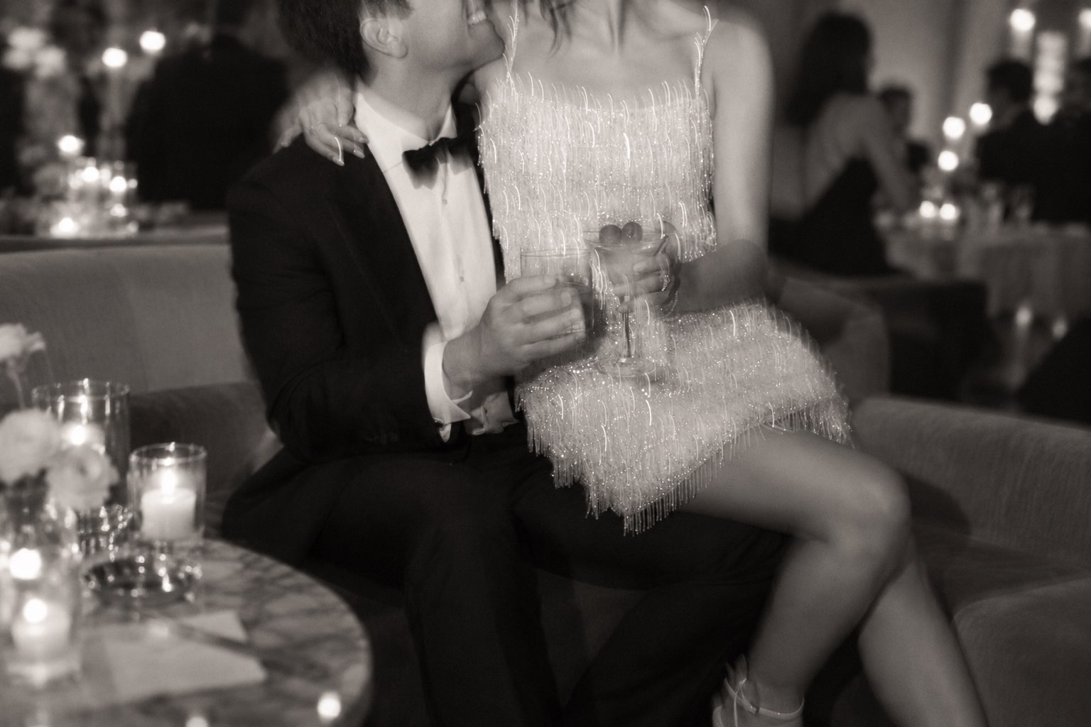 A couple sharing a drink by candlelight at an evening party